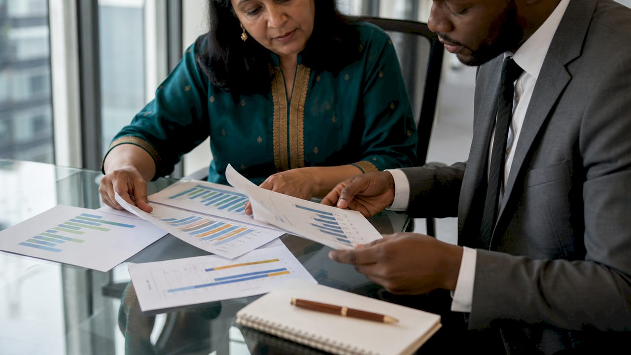 Overhead view of professionals arranging salary data charts