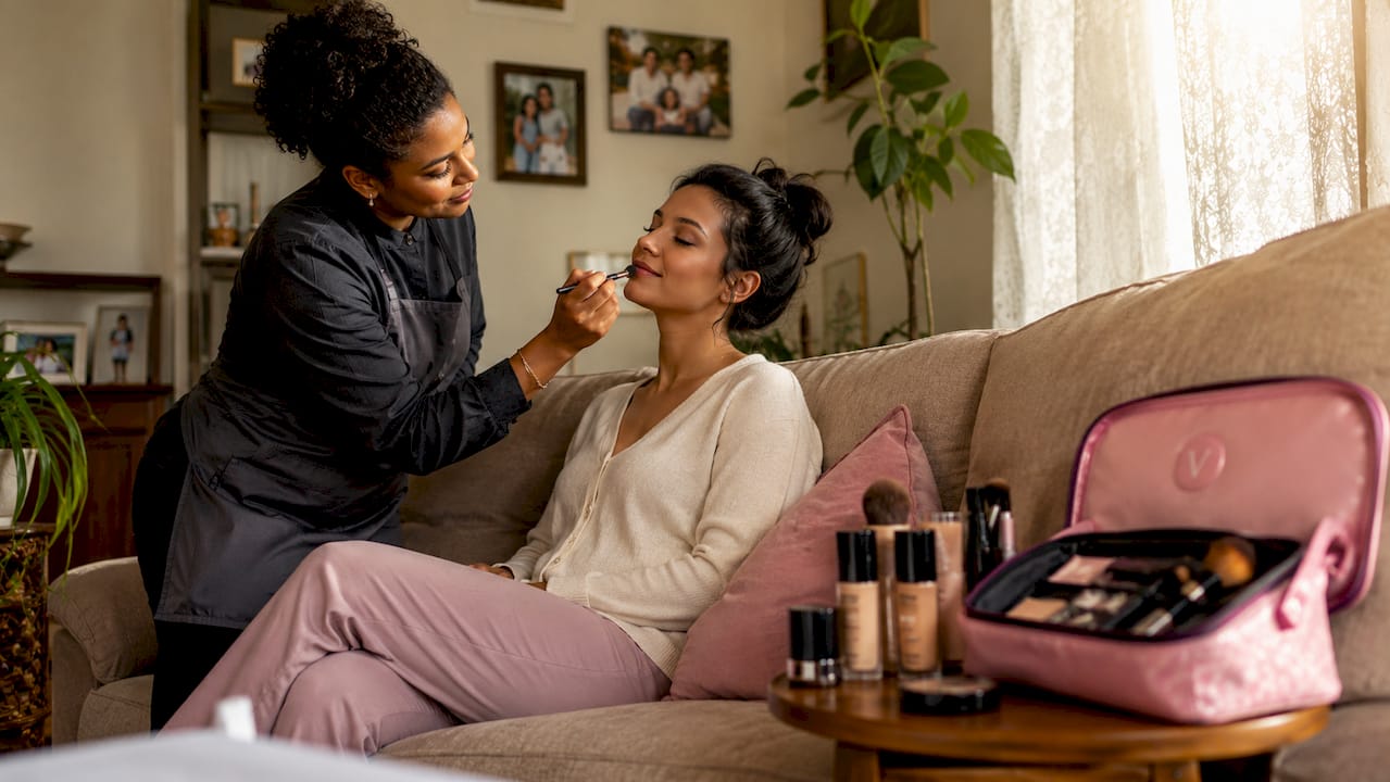 Makeup artist applying makeup on client in natural light