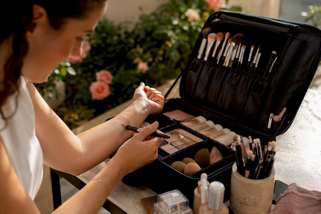 Hands mixing foundation shades for color matching