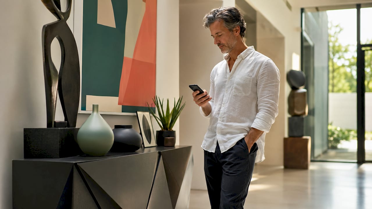 Collector studying art pricing data on tablet