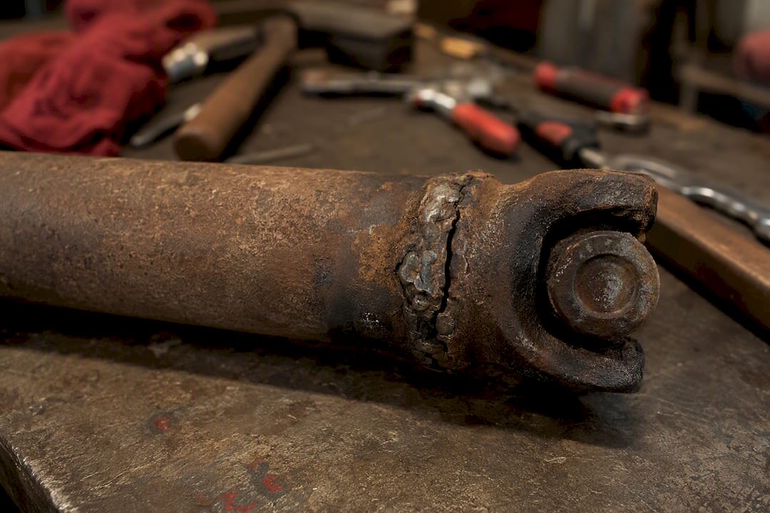 Corroded and cracked driveshaft tube close-up
