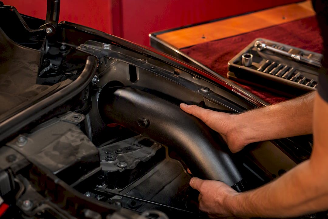 Routing an intake tube through fender well