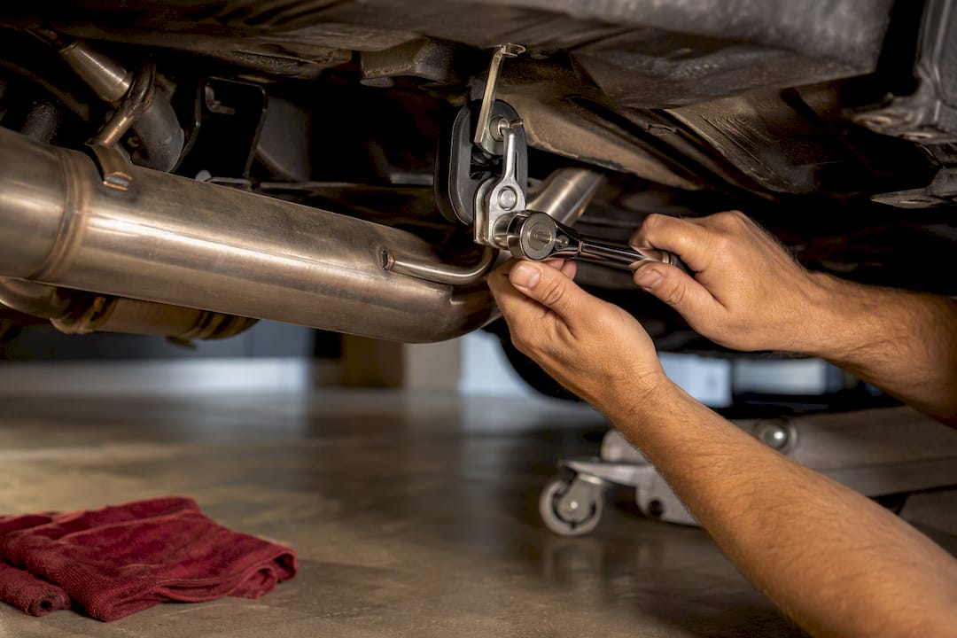 Hands securing exhaust hanger hardware