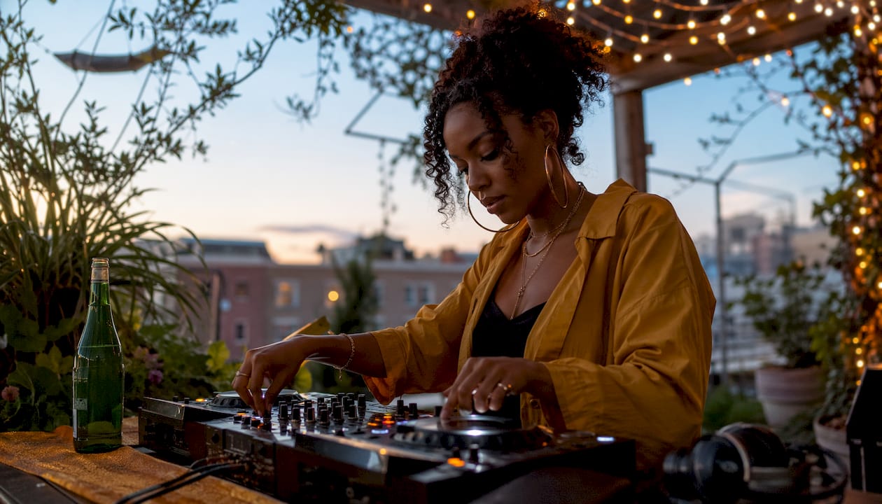 Female DJ mixing live at club booth