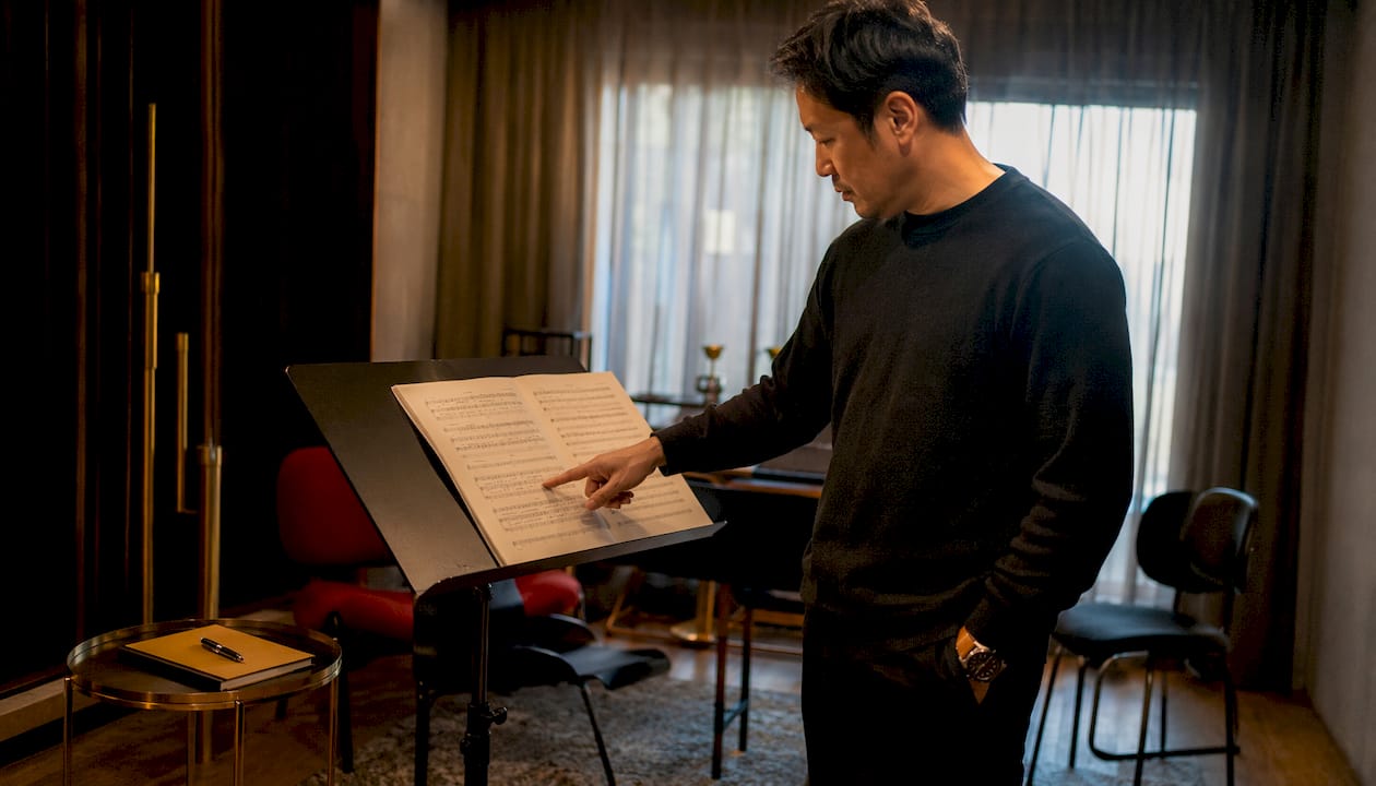 Composer reviewing orchestral score with dynamics