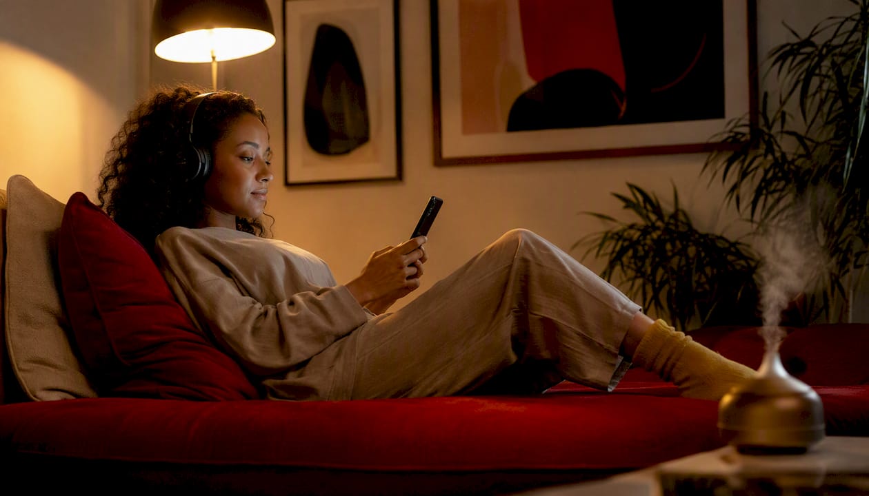 Woman lying in bed listening to sleep music