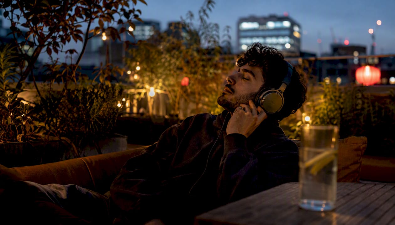 Person with vintage headphones listening thoughtfully
