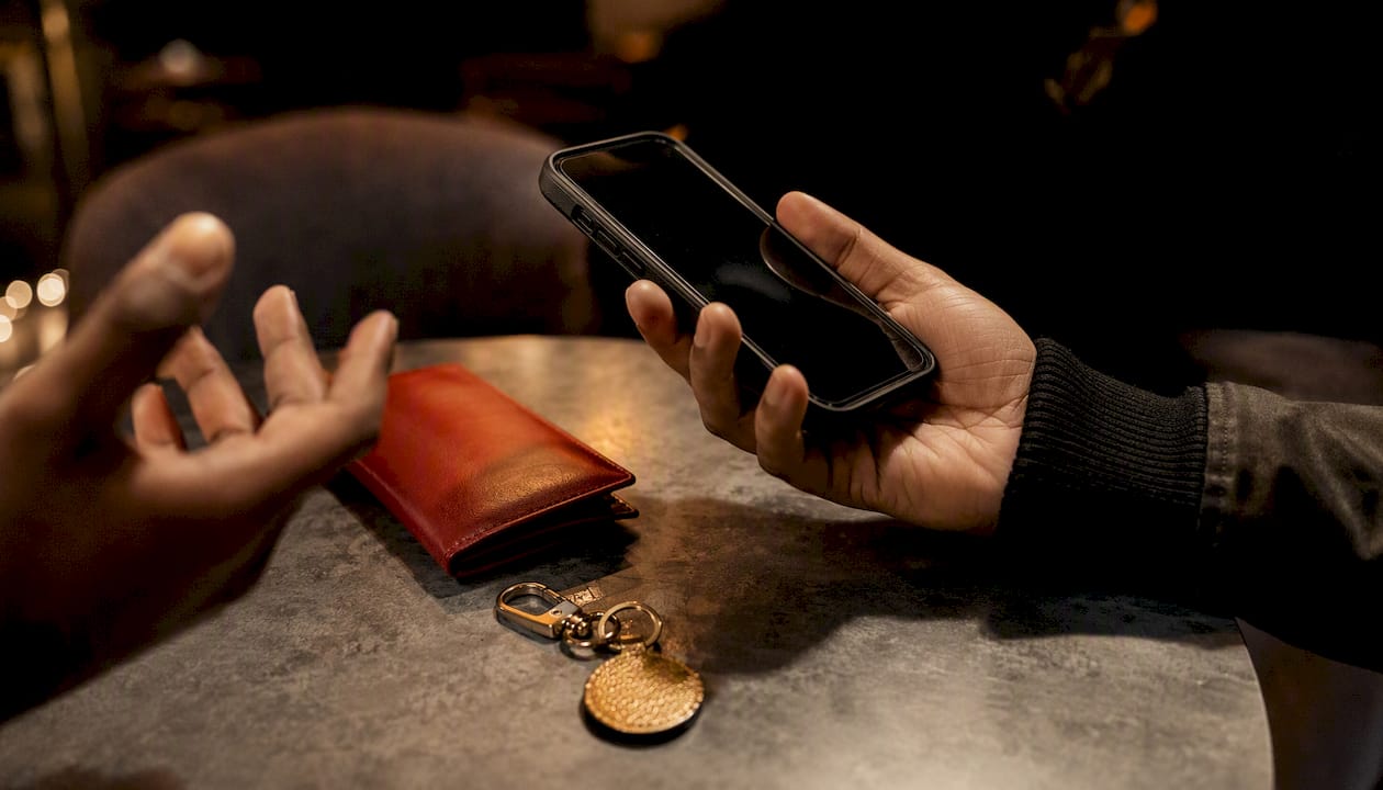 Hand holding smartphone about to share music