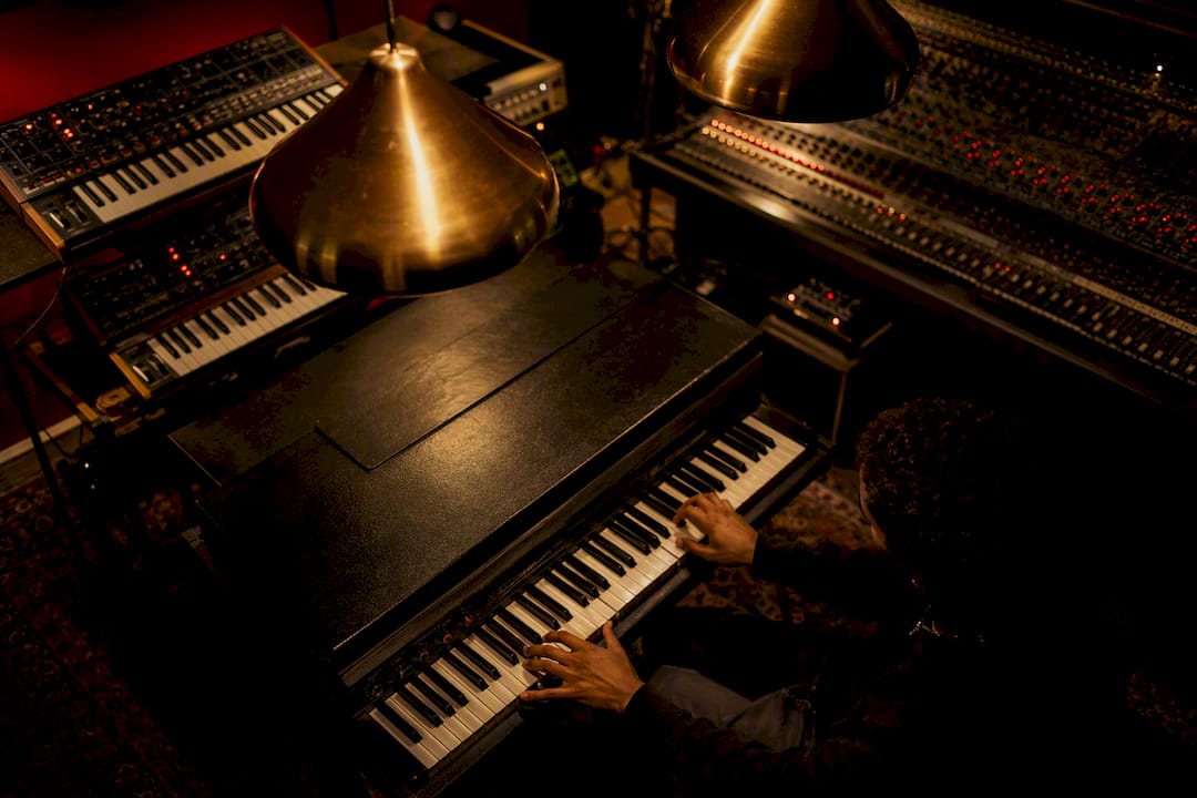 Hands playing Rhodes piano in intimate studio