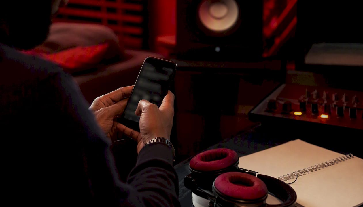 Hands interacting with smartphone and music tools