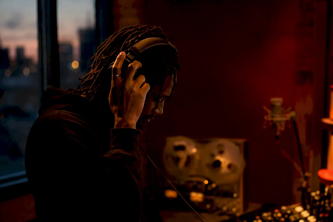 Musician adjusting headphones in studio