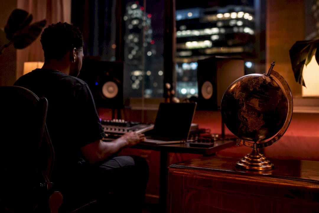 Desk with globe and digital audio setup in warm light
