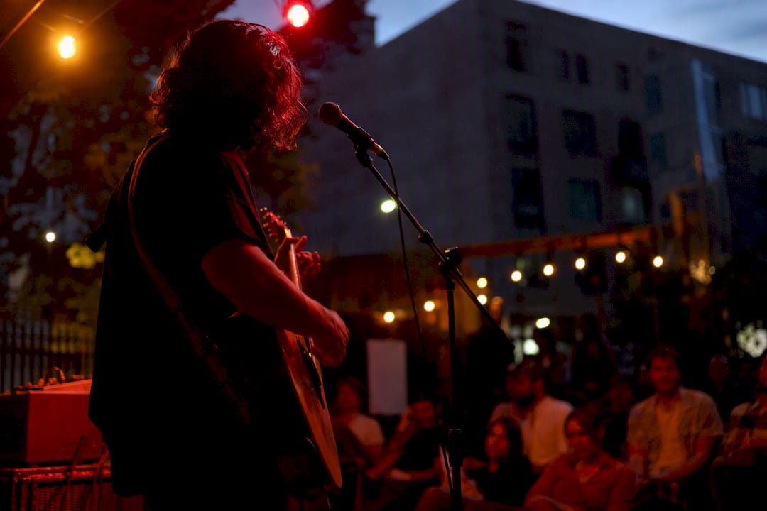 Musician mid-performance at intimate showcase