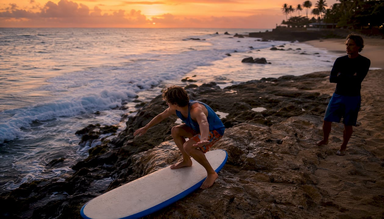 Surfer practicing pop-up stance on beach