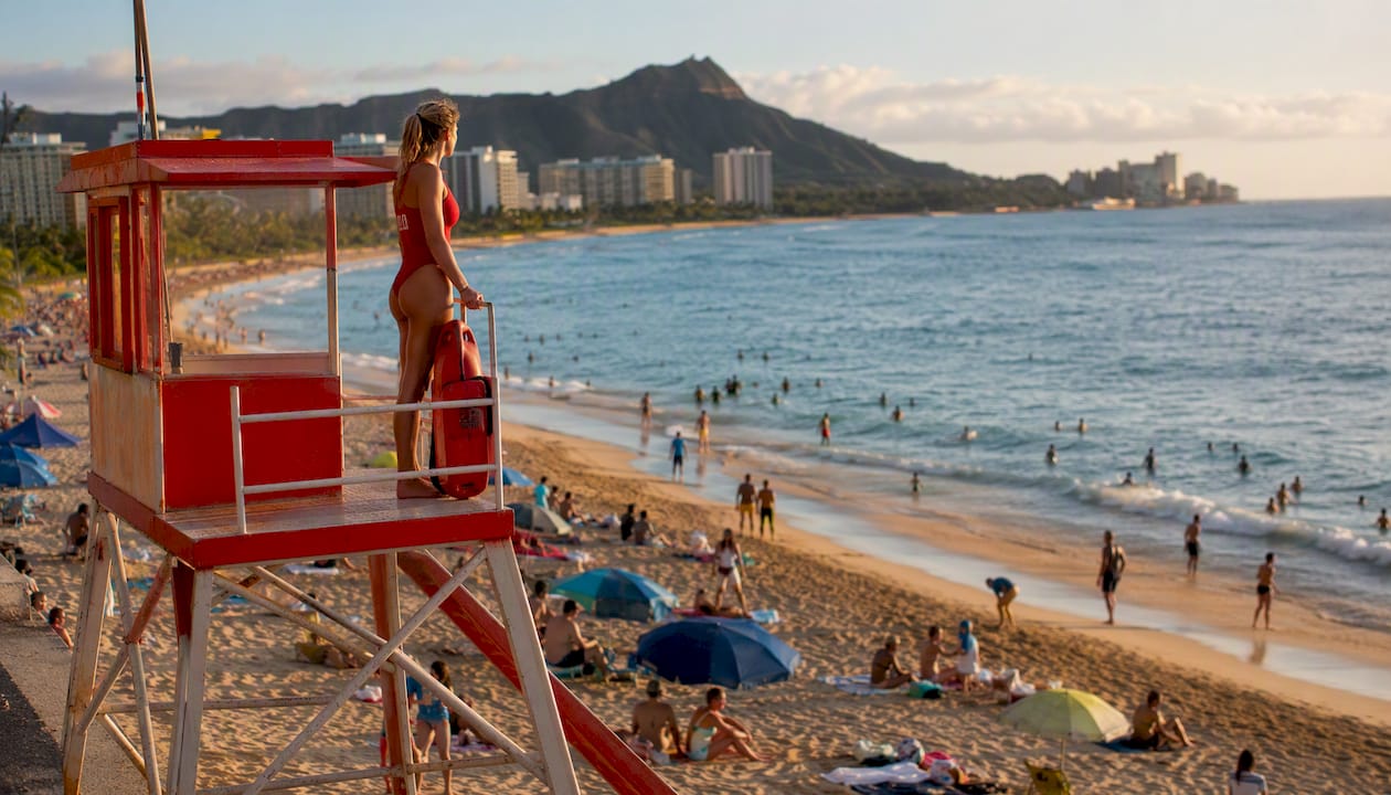 Lifeguard monitoring surf beach from tower