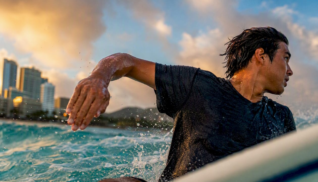 Surfer's back arm bent at 90 degrees for stability