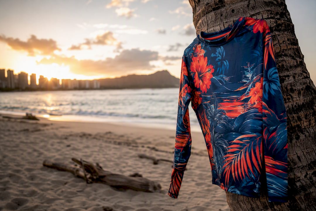 Colorful rash guard on beach rock with swim gear