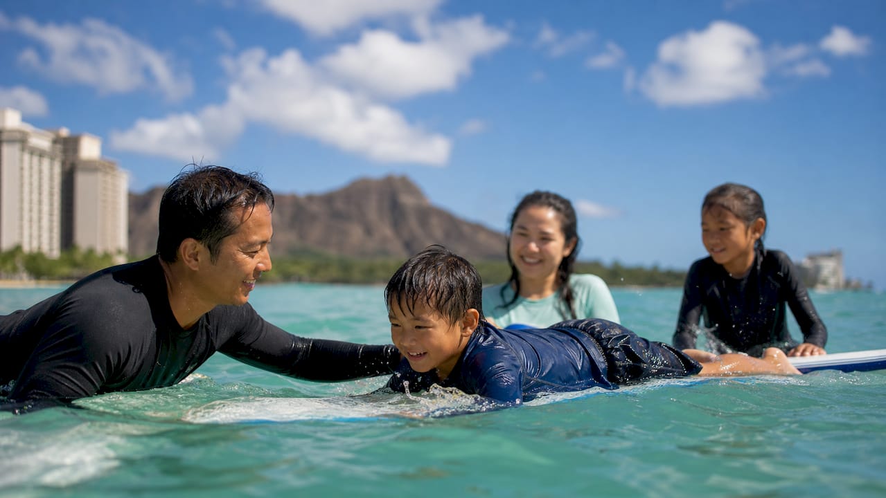 Instructor coaching family in private surf lesson