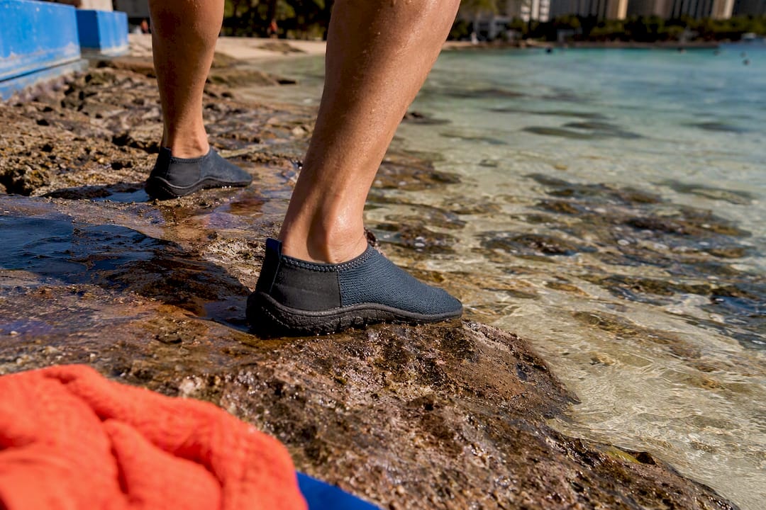 Water shoes crossing shallow rocky reef entry