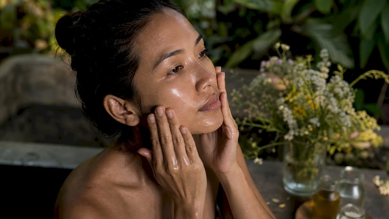 Hands applying moisturizer for sensitive skin
