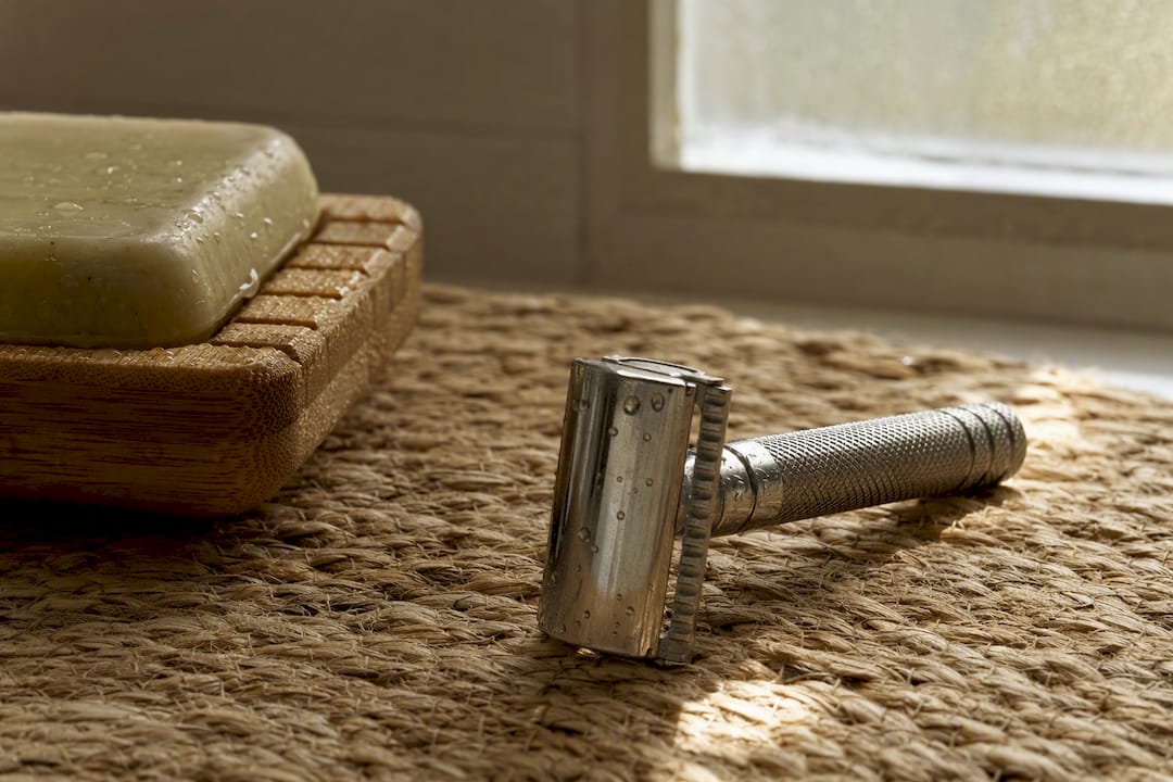 Metal safety razor on natural linen cloth