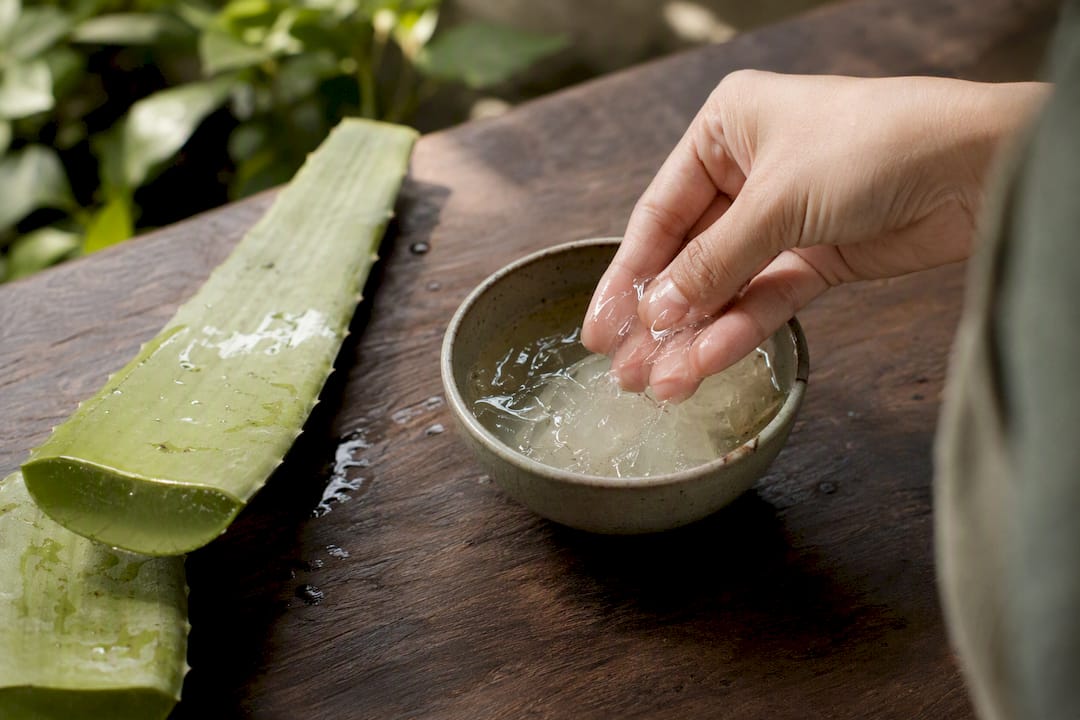 Fresh aloe vera gel on wooden surface