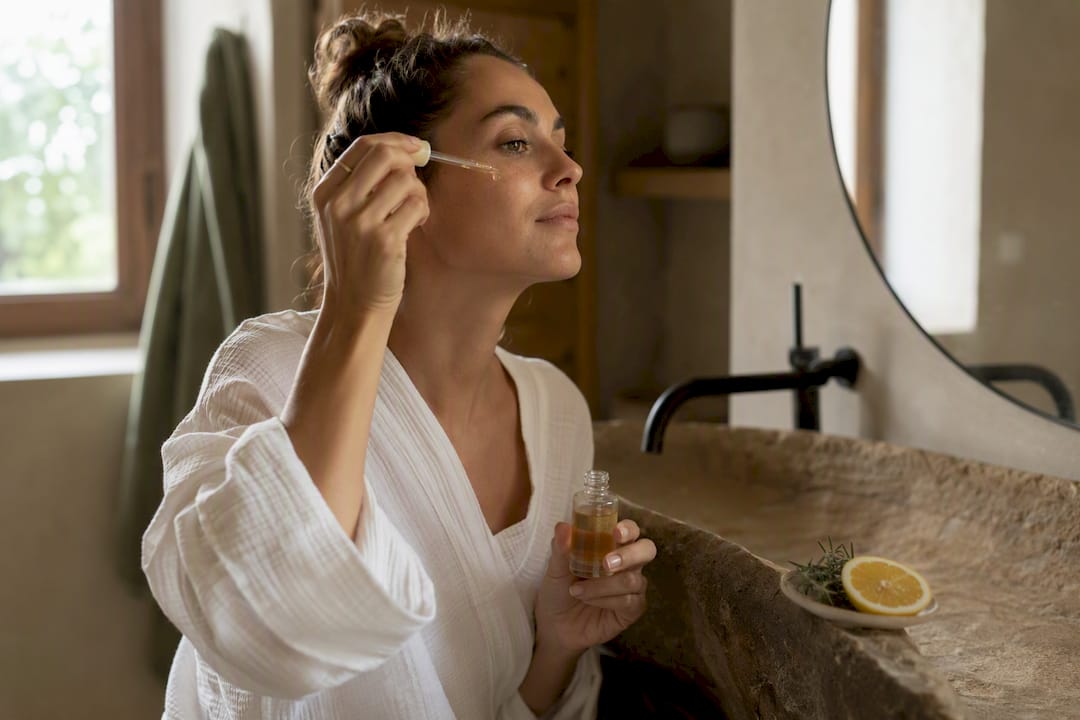 Applying vitamin C serum on skin