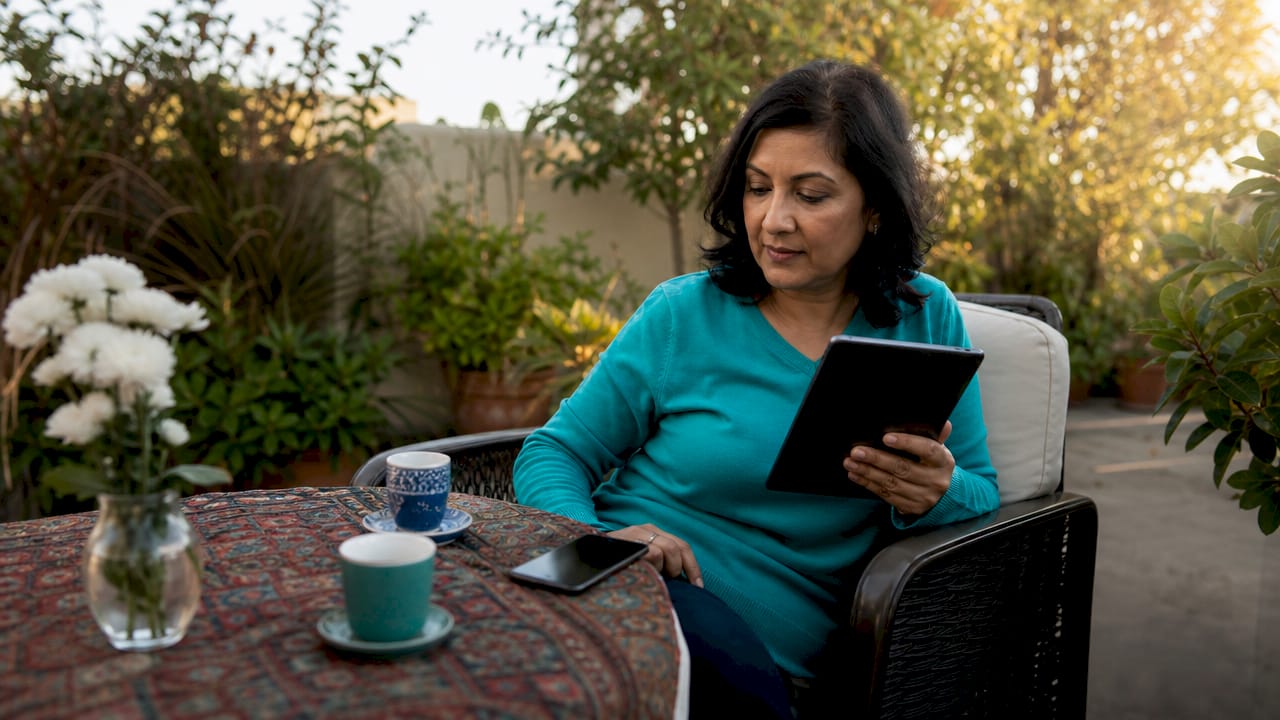 Woman managing wishlist on tablet at home