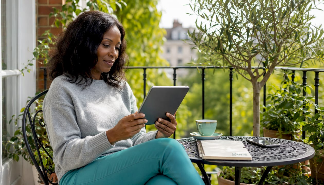 Woman browsing online gifts at kitchen table