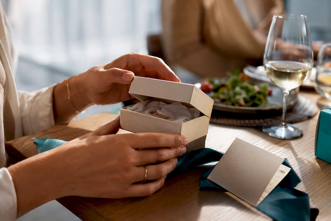 Hands opening a personalised graduation keepsake