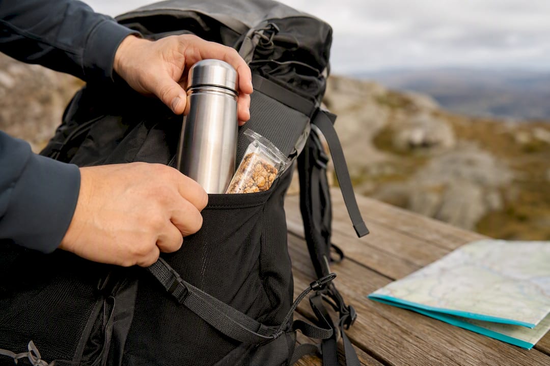 Flask and snack packed into hiking rucksack