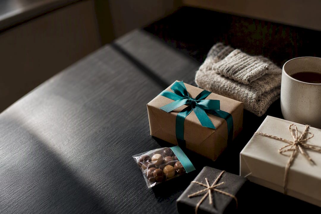 Small wrapped Secret Santa gifts on table