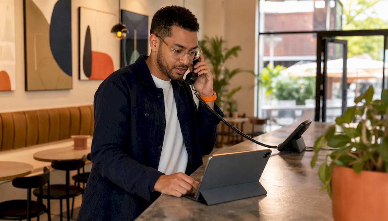 Man answering call at modern office desk