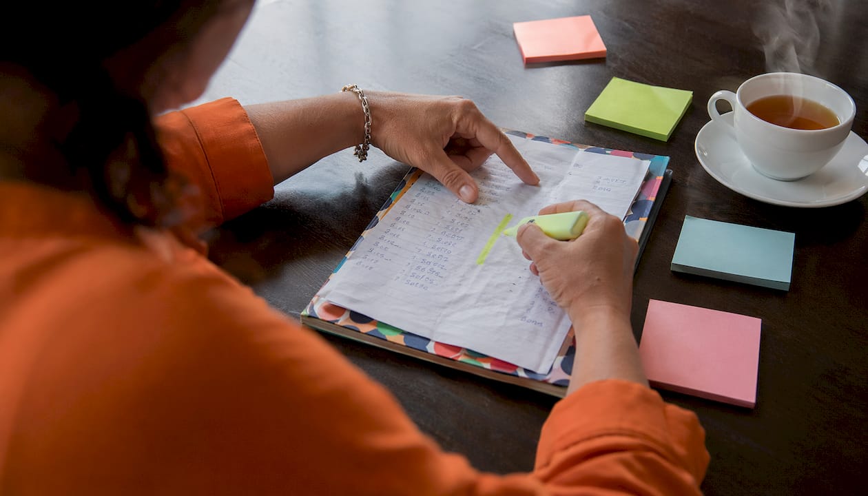 Hands analyzing call logs on desk
