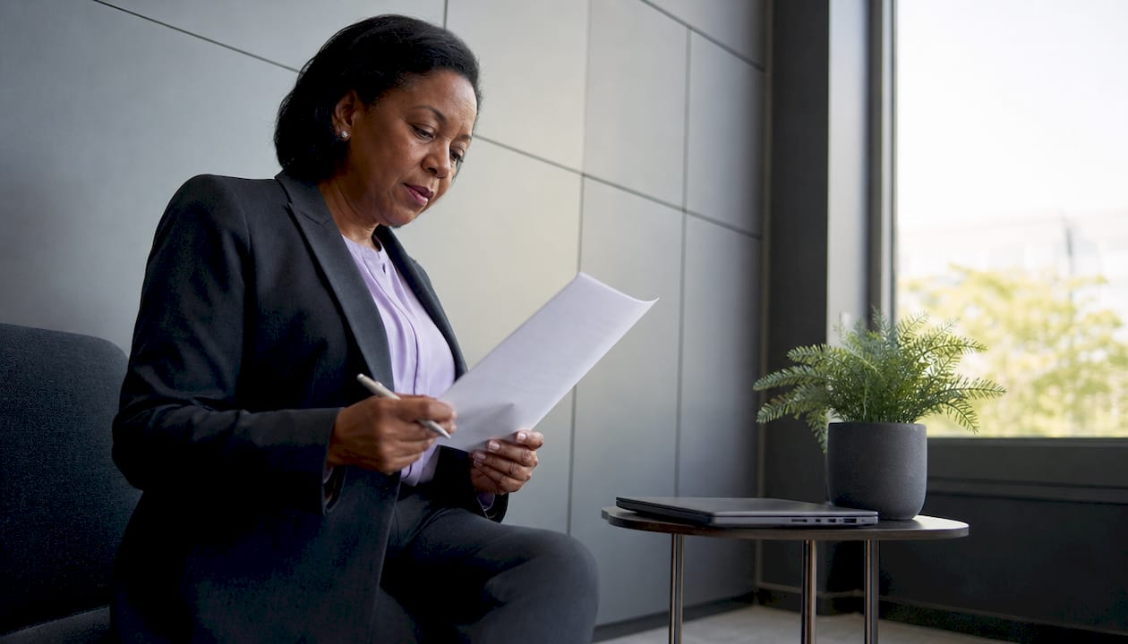 Woman reviewing AI governance policies at desk