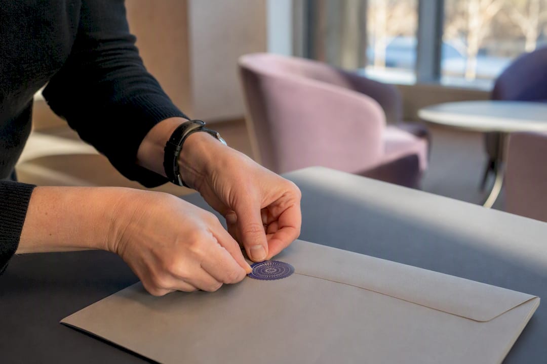 Hands sealing cryptographic audit document