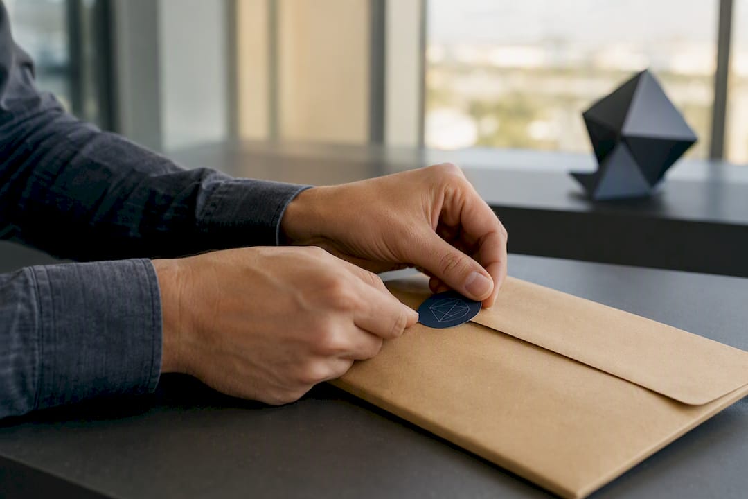 Hands applying cryptographic tamper-evident seal
