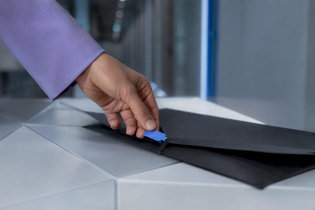 Hand applying audit evidence seal