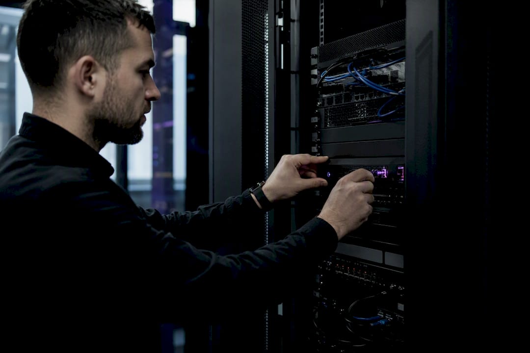 Hands adjusting firewall controls in data center