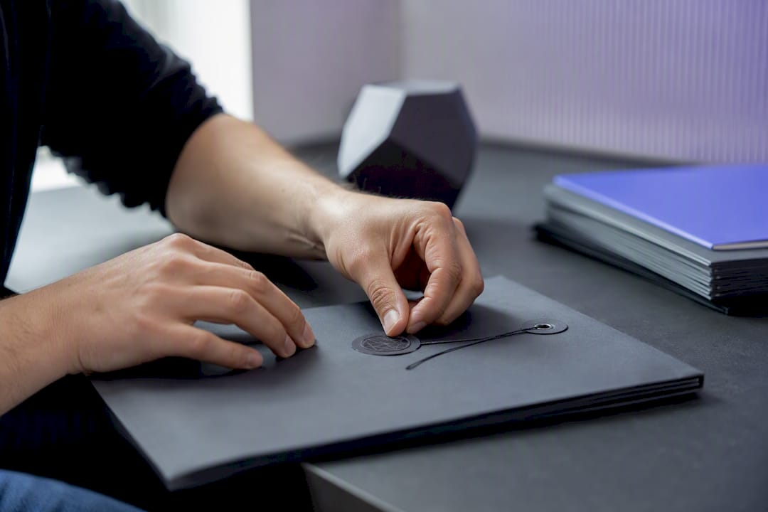 Hands applying cryptographic seal to evidence pack