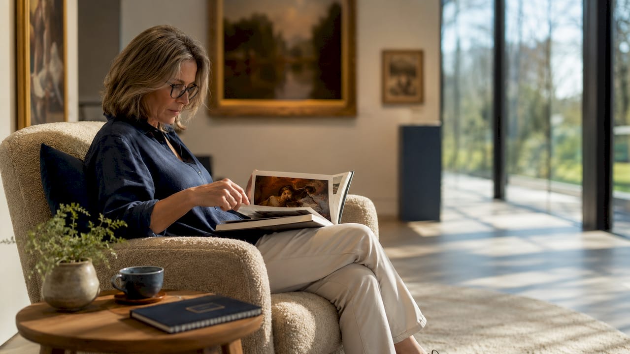 Woman reading art book in museum reading room