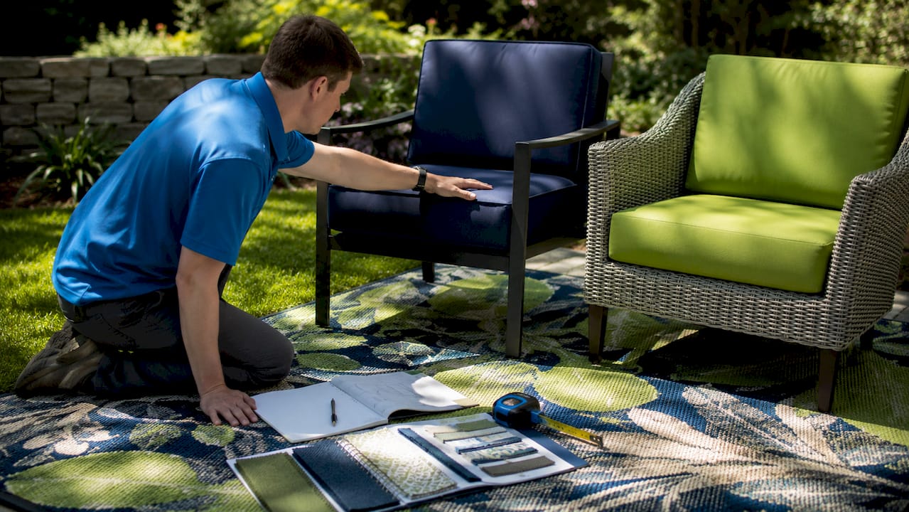 Hands comparing commercial and residential outdoor furniture