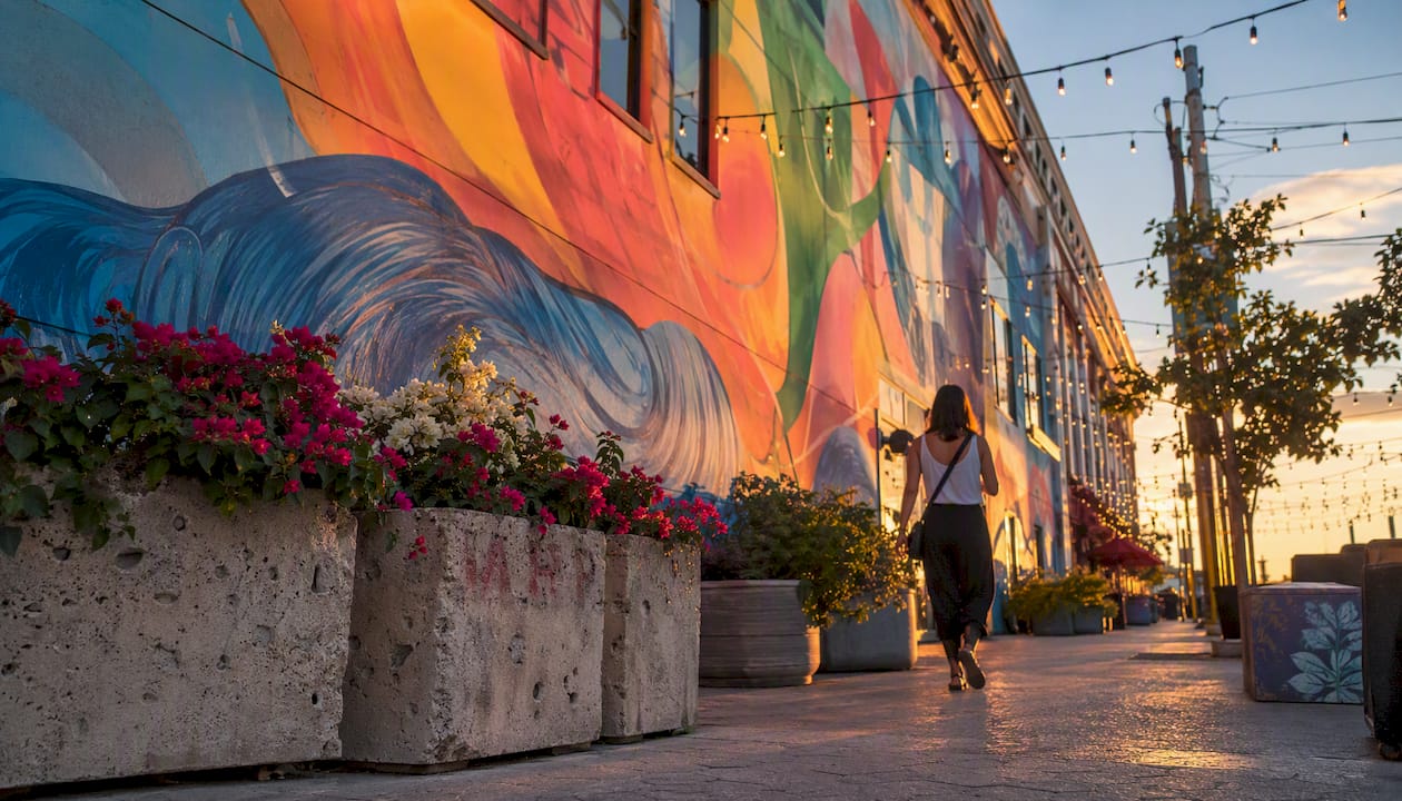 Colorful street-level mural along pedestrian walkway