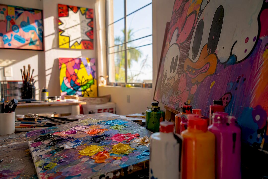 Colorful pop art studio corner with tools and prints