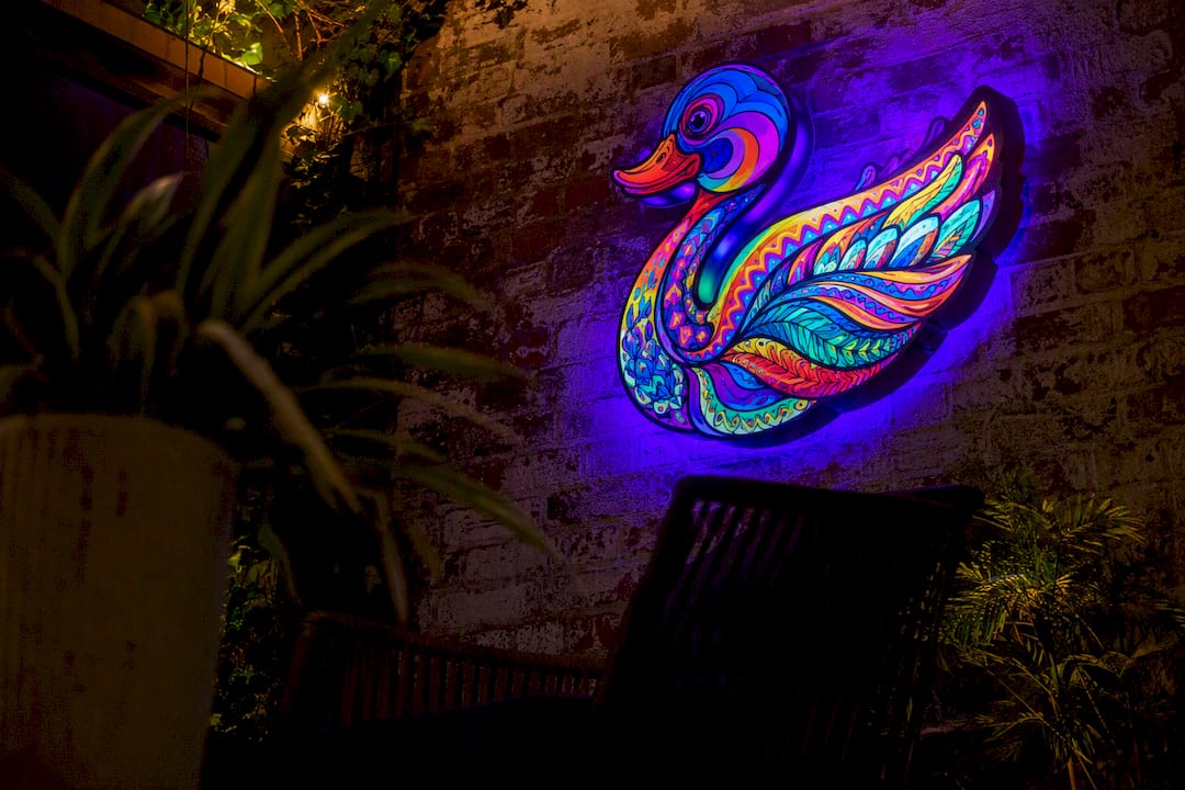 Glowing UV-reactive pop art sculpture under blacklight