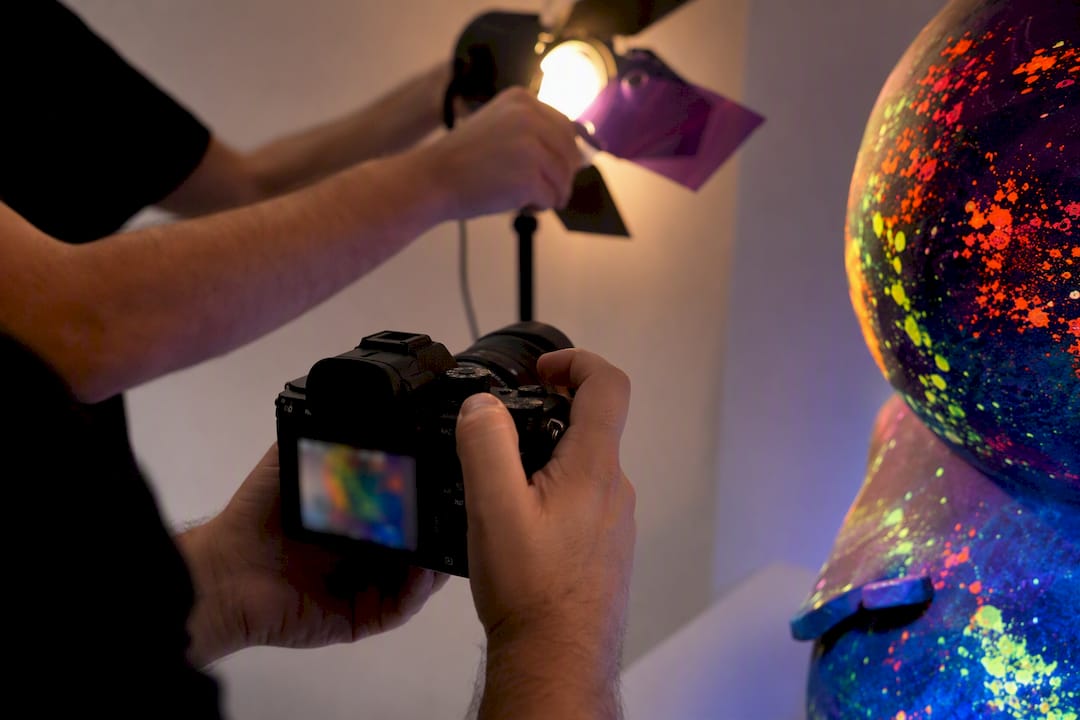 Photographer documenting artwork under blacklight