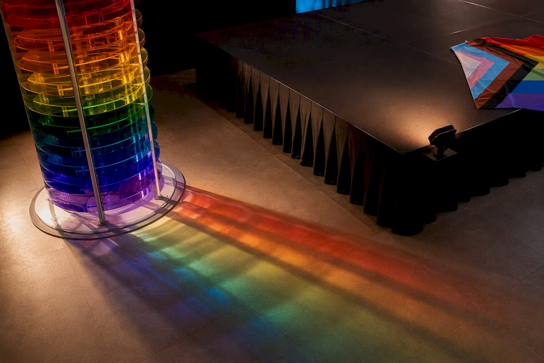Rainbow sculpture casting shadows on dance floor