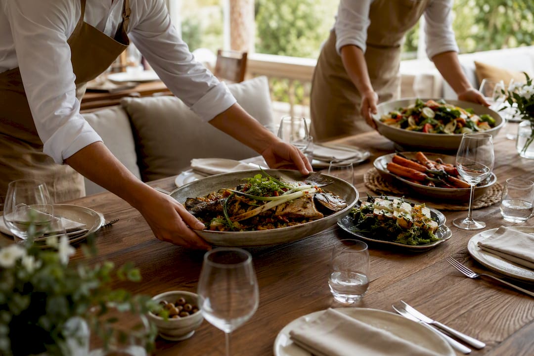 Restaurant staff placing shared platters