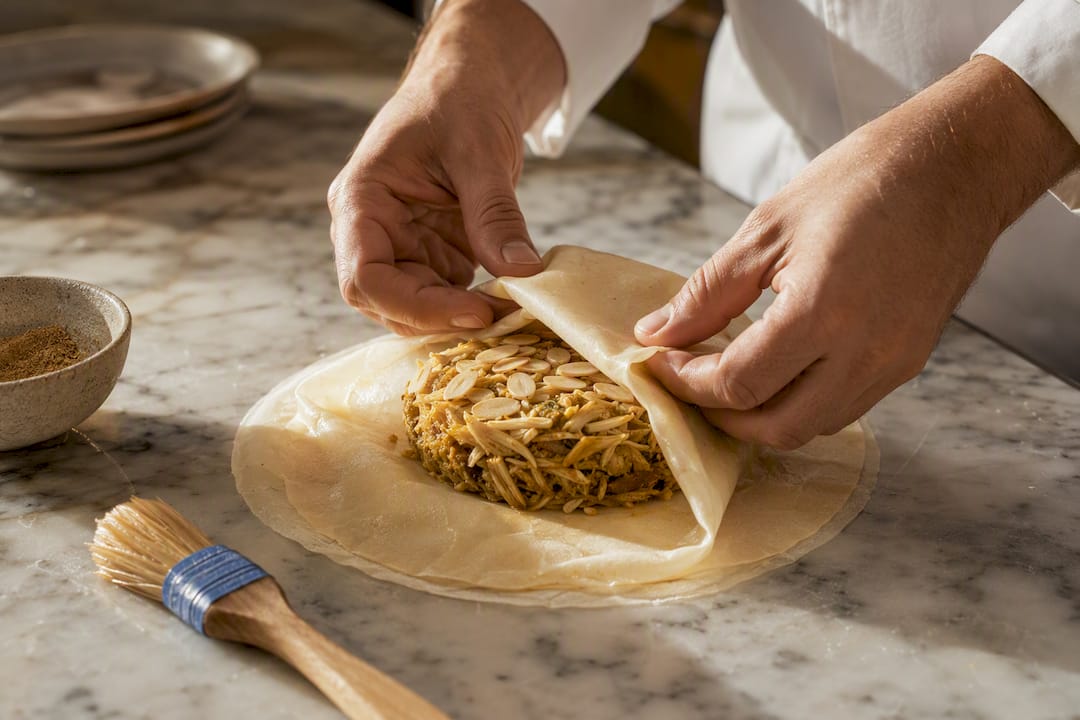 Hands folding pastela pastry carefully