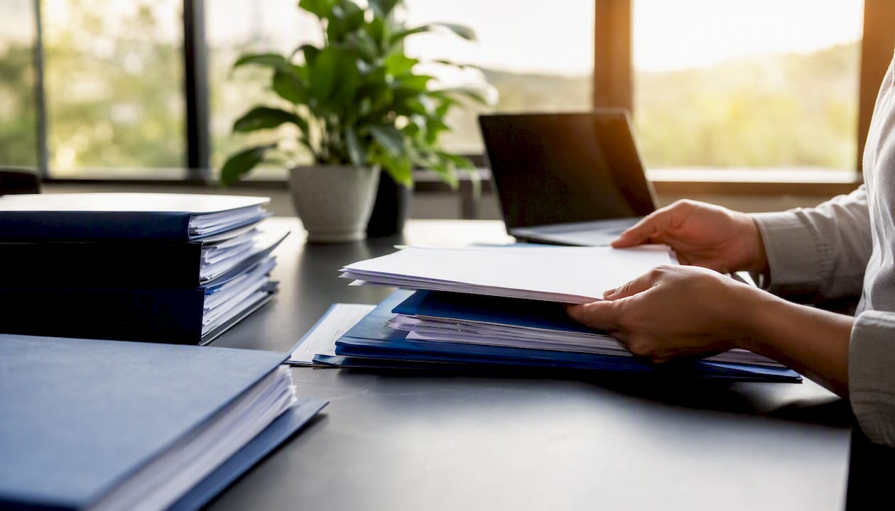 Hands organizing contracts and delivery notes